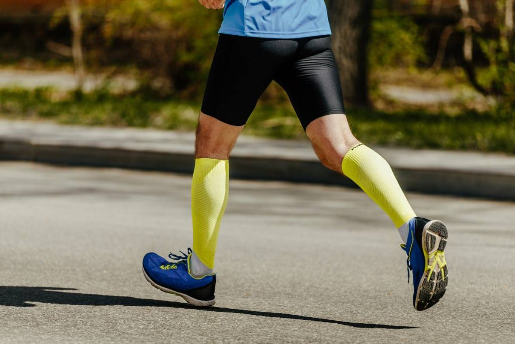 runner wears yellow compression socks